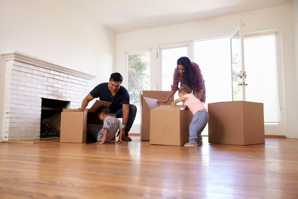 Family packing boxes at home, reflecting the psychology behind storage decisions.