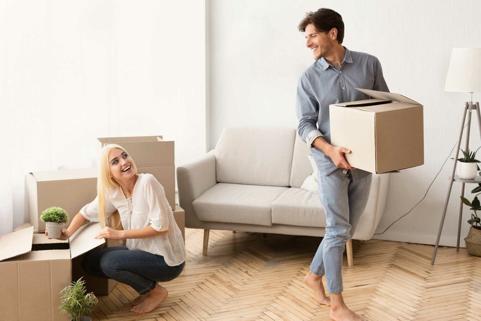 young-married-couple-unpacking-moving-boxes-in-new-MJN76X5-1536x1024-1