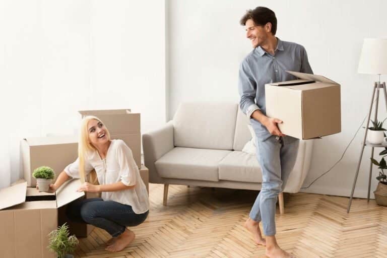 young-married-couple-unpacking-moving-boxes-in-new-MJN76X5-768x512-1