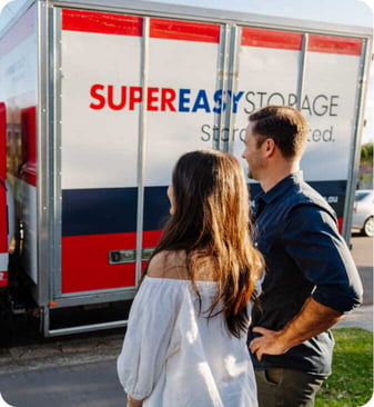 Customers standing beside a Super Easy Storage truck