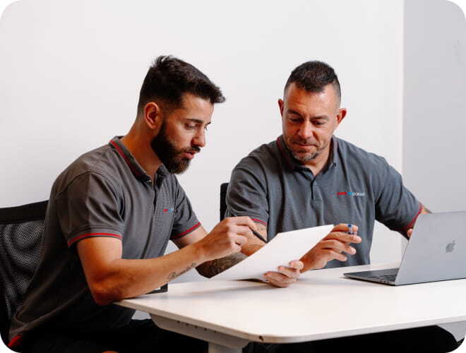 Professional removalists reviewing moving paperwork