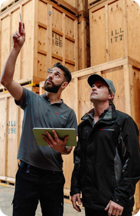 Team members beside stacked mobile storage containers